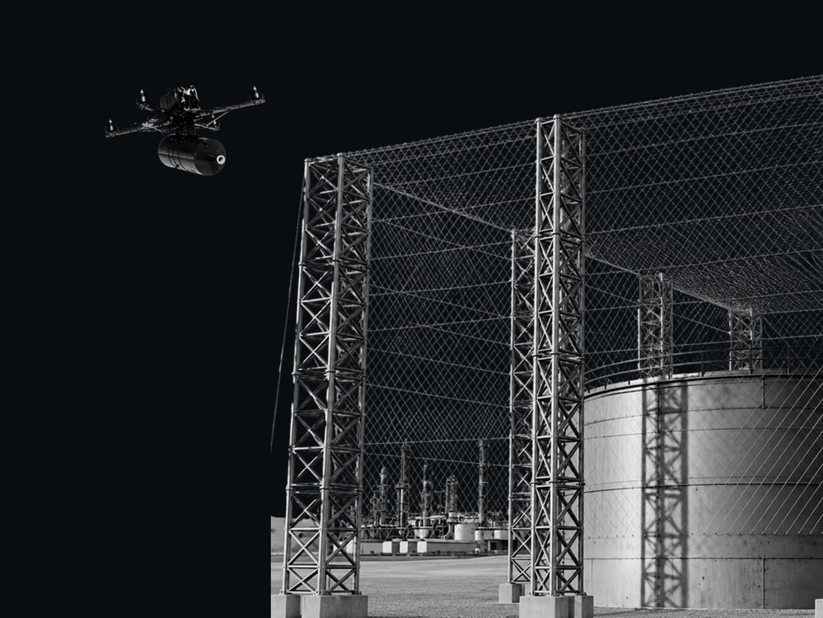 Anti-drone interception net over fuel storage tanks